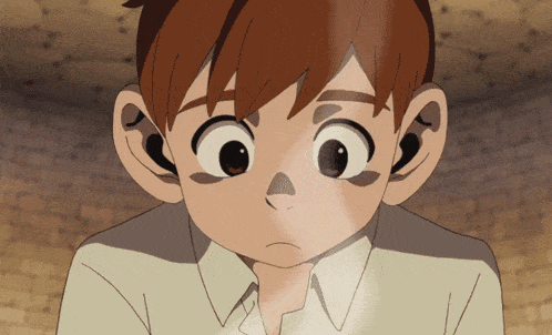a close up of a boy 's face with big eyes