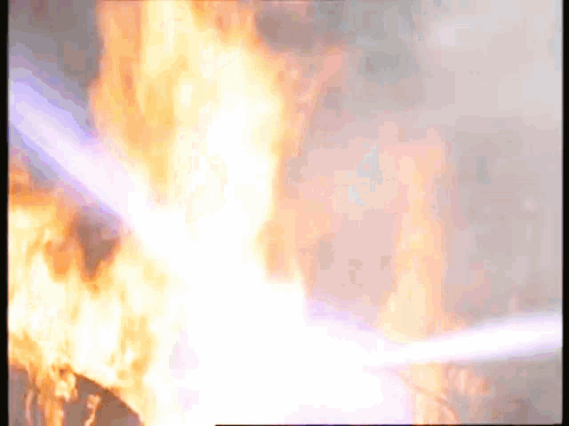 a close up of a fire with a blue light coming from it