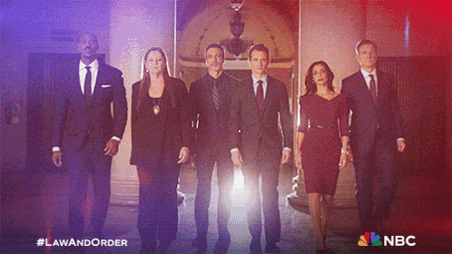 a group of people standing next to each other in suits and ties