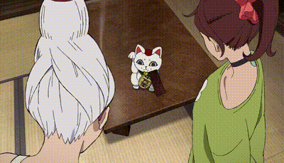a cartoon of two women looking at a cat with chinese writing on it