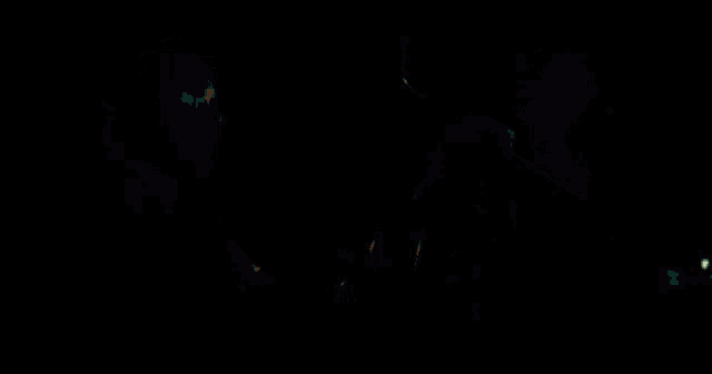 a man is driving a car at night and holding the steering wheel in his hand .