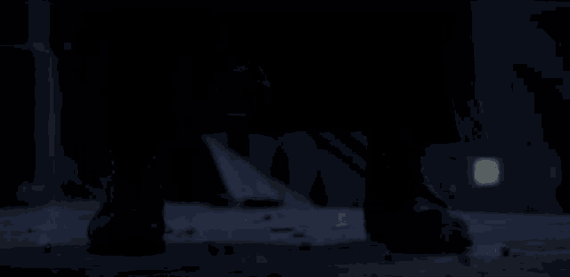 a man in a dark room with a light shining on him
