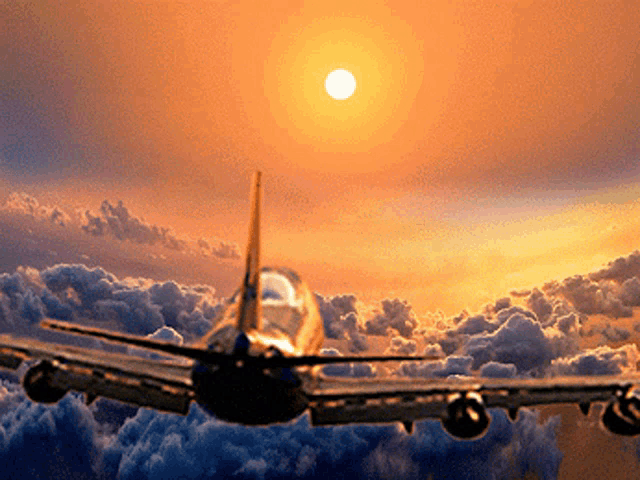 a plane is flying through the clouds with the sun in the background