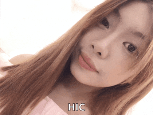 a close up of a woman 's face with hic written on the bottom right