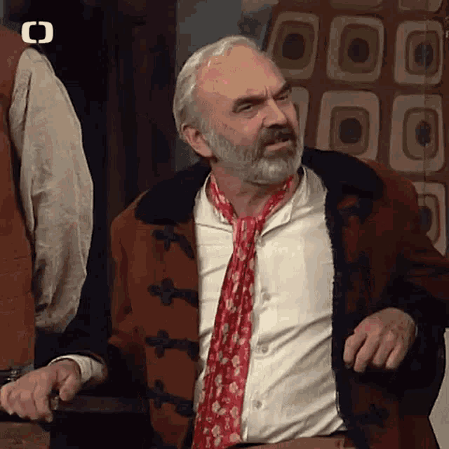 a man with a beard and a scarf around his neck
