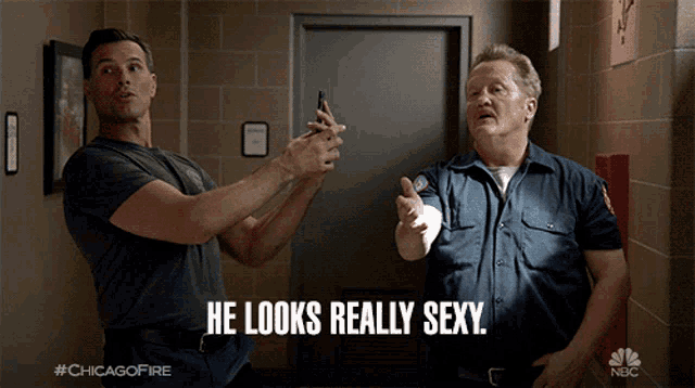 two men are standing next to each other and the caption says he looks really sexy