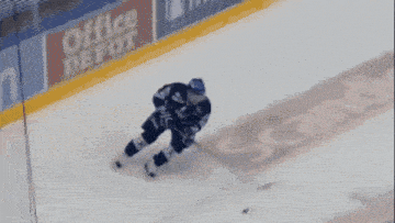 a hockey player is laying on the ice and has the number 5 on his jersey