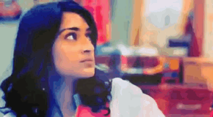 a pixelated image of a woman in a room with a red box in the background