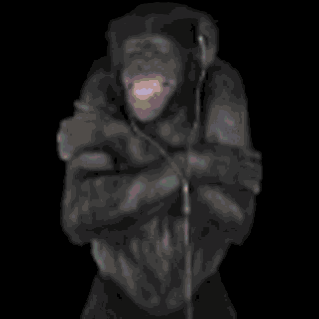a chimpanzee wearing headphones and holding a microphone in the dark .
