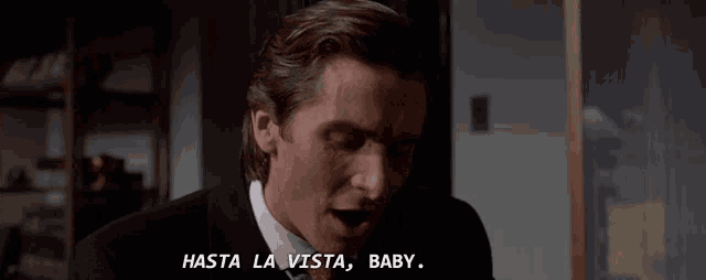 a man in a suit says hasta la vista baby in spanish