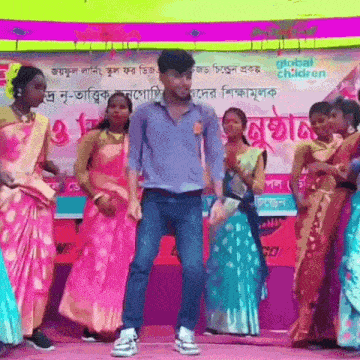 a group of people are dancing in front of a sign that says " global children "