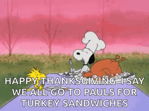snoopy and woodstock are sitting at a table with a turkey sandwich .