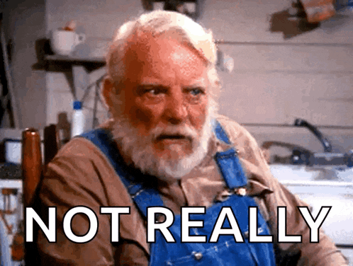a man with a beard is sitting in a chair with the words not really written below him