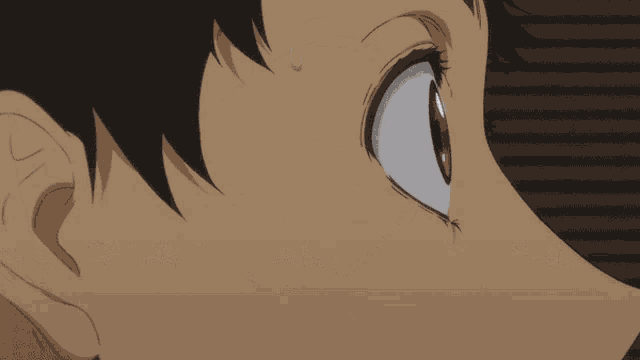 a close up of a person 's face with a tear coming out of their eye