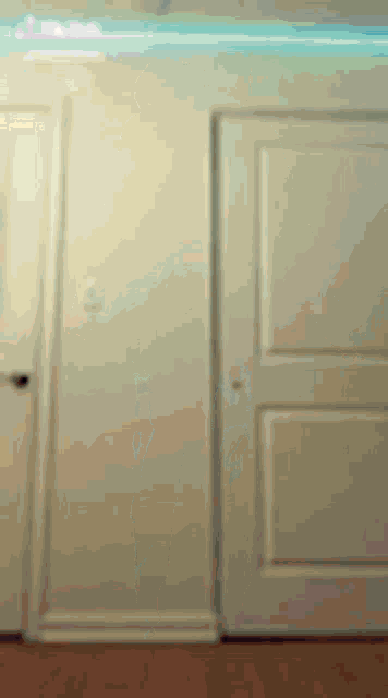 a blurred image of a door in a room with a light on the ceiling .