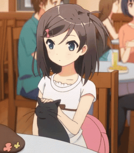 a girl is sitting at a table with a black cat