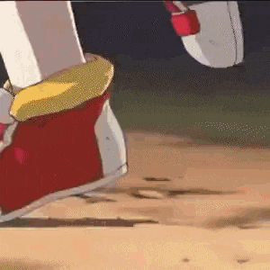 a close up of a person 's foot wearing a pair of red and yellow shoes .