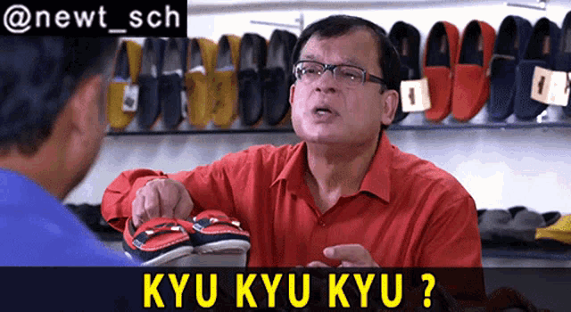 a man in a red shirt is pointing at a pair of shoes with the words kyu kyu kyu below him