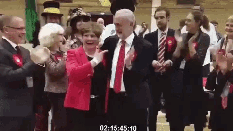 a man in a suit and tie is dancing with a woman