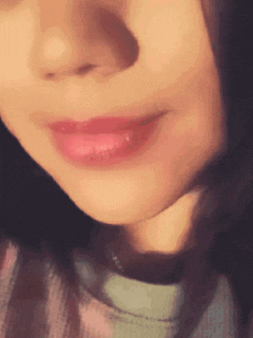 a close up of a woman 's mouth with red lipstick on