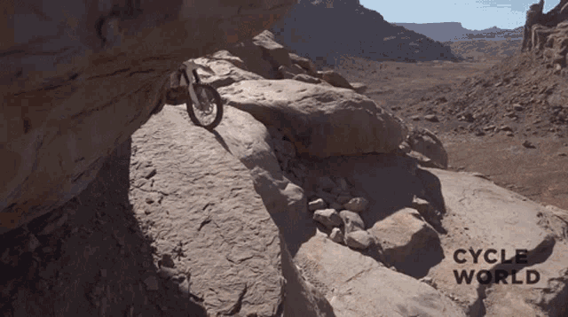 a person riding a bike on a rocky trail with the words cycle world below
