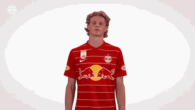 a man in a red shirt with a bull on it