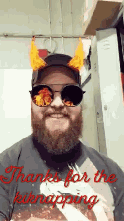 a man with a beard wearing sunglasses and a hat with flames on his ears says thanks for the kidnapping