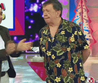 a man wearing a hawaiian shirt is talking to another man
