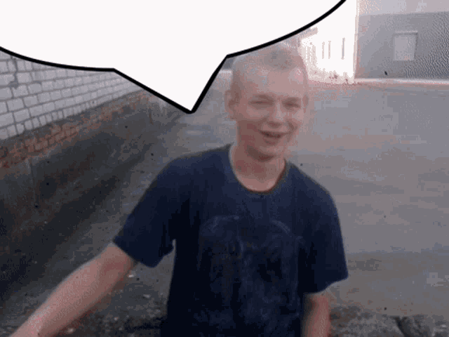 a boy in a blue shirt is smiling with a speech bubble behind him