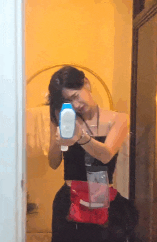 a woman taking a picture of herself in a mirror