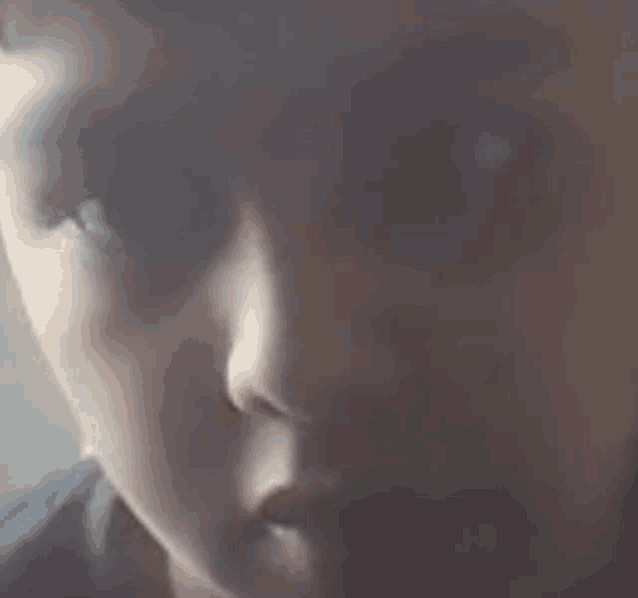 a close up of a young boy 's face with a blurred background .