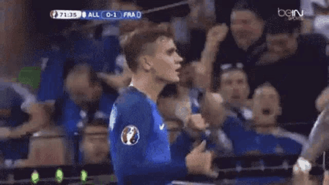 a soccer player wearing a number 18 jersey is giving a thumbs up