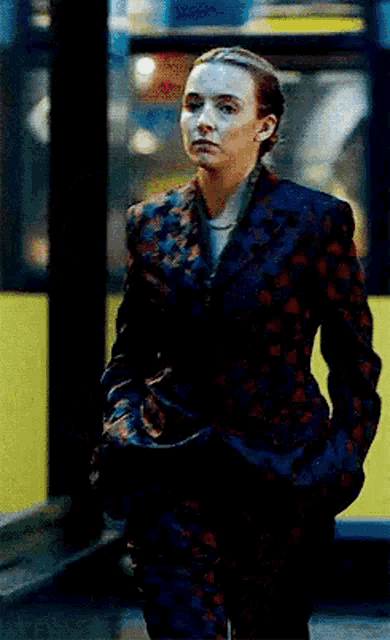 a woman in a suit is walking down the street