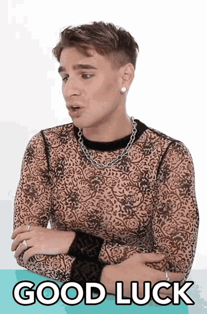 a man wearing a leopard print shirt and a chain around his neck says good luck