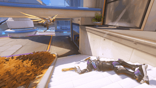 a person is laying on a set of stairs with a gun