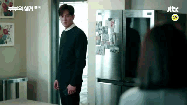 a man standing in front of a refrigerator with a jtbc logo on the bottom