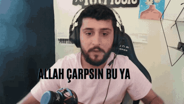 a man wearing headphones with the words allah carpsin bu ya on his shirt