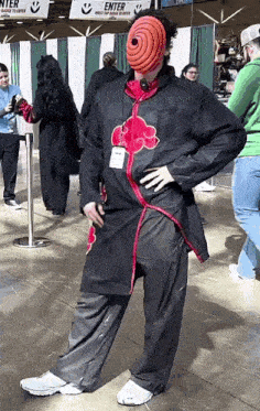 a man in a costume is standing in front of an enter sign