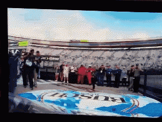 a bunch of people standing around a budweiser advertisement