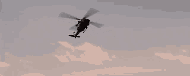 a helicopter is flying through a cloudy sky and has the word rescue on the side