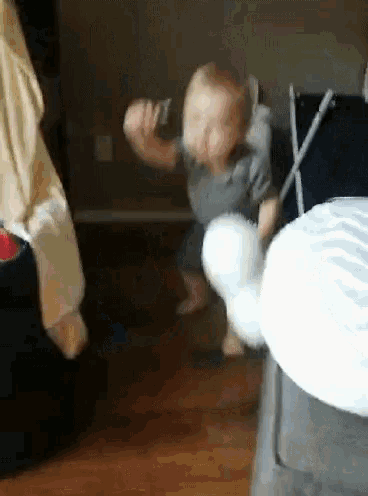 a little boy is playing with a stuffed animal