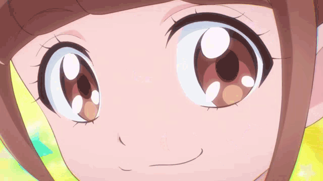 a close up of a girl 's eyes with a yellow star in the background