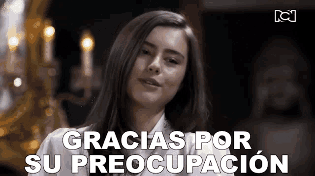 a woman in a white shirt is smiling and says gracias por su preocupacion .