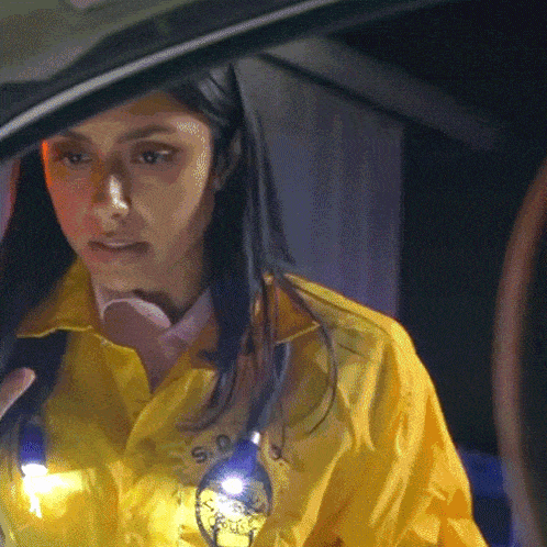 a woman wearing a yellow jacket that says s.d. on it
