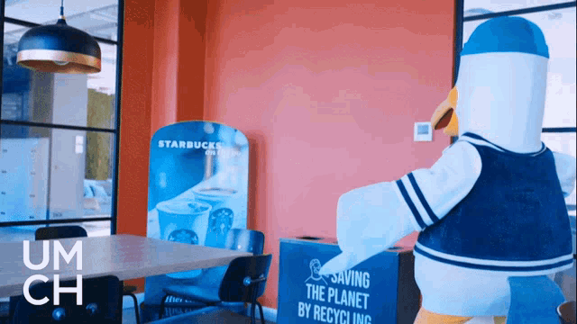 a duck mascot is standing in front of a starbucks sign