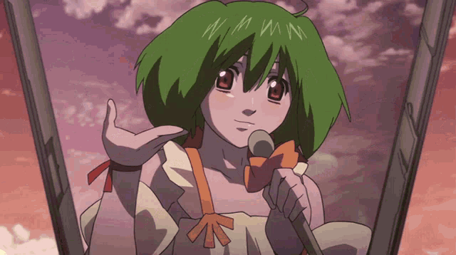 a girl with green hair is singing into a microphone with the letter n on her forehead