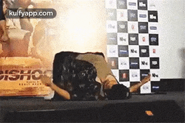 a man is laying on his stomach on a table .