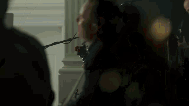 a man with a beard is singing into a microphone in a band .