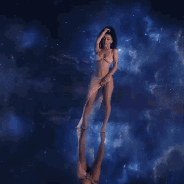 a woman in a very short dress is standing in the middle of a galaxy .