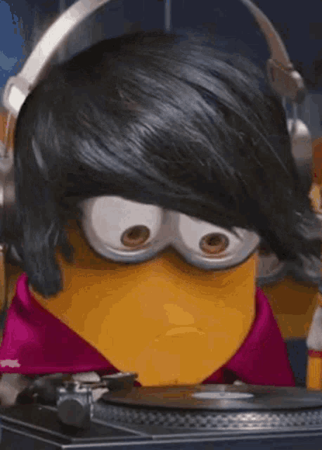 a cartoon minion is wearing headphones and playing a record .